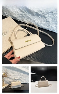 Close-up of white lychee pattern leather handbag featuring yellow FASHION lettering
