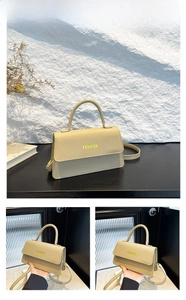 Detail of khaki litchi grain leather handbag with yellow FASHION text and strap