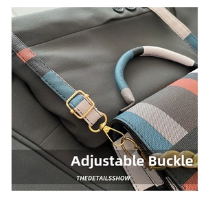 Close-up of golden adjustable buckle and decorative chain on checkered shoulder bag