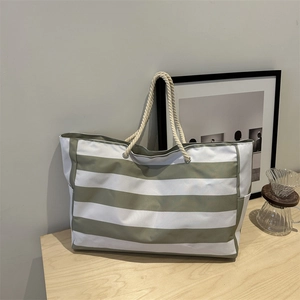 Large striped canvas tote bag with cotton rope handles for women commuting or beach travel