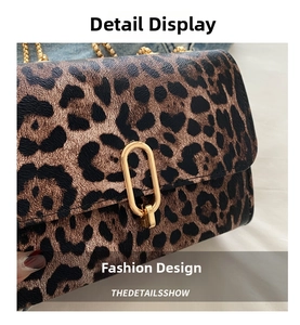 Detailed close-up of leopard print crossbody bag with gold U-shaped metal buckle and chain