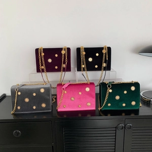 Five vintage velvet chain bags in various colors featuring gold sun-patterned rivets