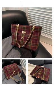 Detail of red plaid wool tote bag featuring gold chain strap and deer pendant charm