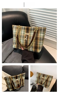 Detail of green plaid woolen tote bag with deer charm and gold chain leather strap