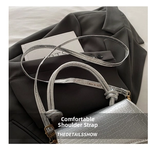 Detail view of silver crocodile texture PU leather crossbody bag with knot handle and strap