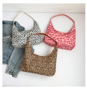 Flat lay of leopard print hobo tote bags in yellow, black and pink heart patterns