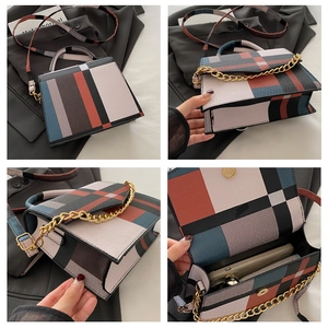 Detail view showing color-block plaid pattern and gold chain on the structured crossbody bag