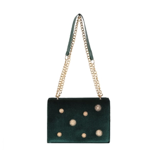 Green velvet crossbody bag with golden sun hardware and dual metal chain straps