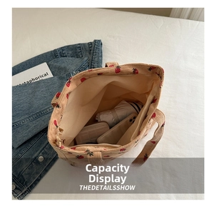 Interior view of corduroy strawberry tote showing large capacity for phone and umbrella