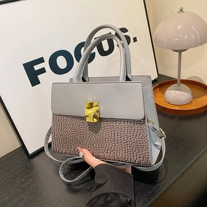 Gray crocodile-patterned crossbody handbag with gold buckle and stylish top handle