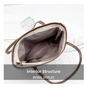 Top-down view of large tote bag internal structure with dark lining and zipper closure