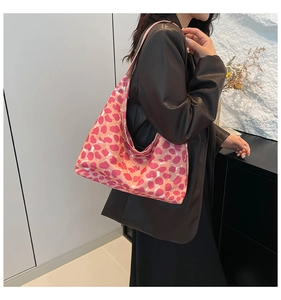 Detail of pink leopard print hobo shoulder bag in glossy faux leather finish
