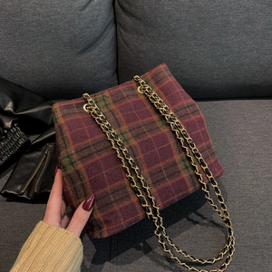 Plaid woolen bucket bag with gold chain strap in wine red and green tartan pattern