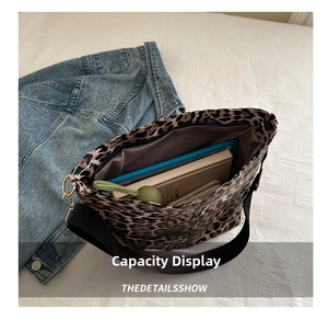 Top-down view of large leopard print tote bag showing spacious interior with tablet and books