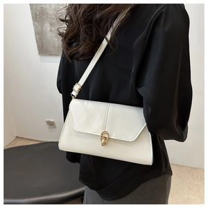 Detail of white glossy PU leather bag with elegant golden double-ring buckle clasp