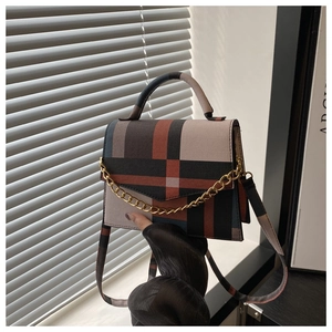 Detail of vintage plaid square bag with gold chain and tricolor checkered pattern