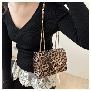 Detail showing high-quality leopard print leather texture and golden metal buckle