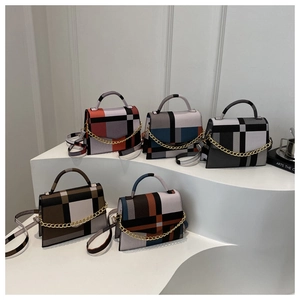 Detailed arrangement of five geometric patchwork handbags with gold chains and straps