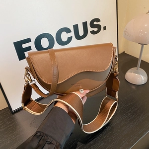 Classic brown textured saddle bag with two detachable straps shown in a high-angle view