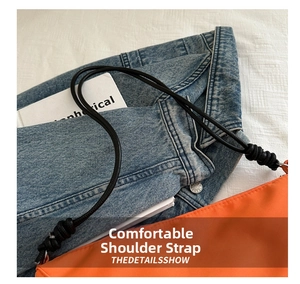 Detail of an orange nylon crossbody bag featuring a thick black knotted shoulder strap