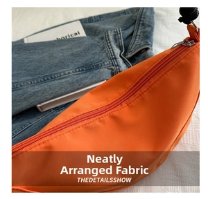 Detail of high-density orange nylon fabric with smooth zipper and neat stitching