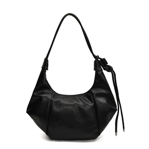 Minimalist black pleated crescent hobo bag with knotted shoulder strap on white background