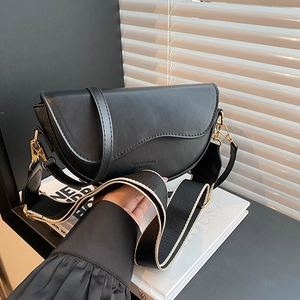 Classic black saddle bag in matte PU leather with dual interchangeable straps and gold hardware