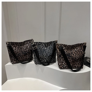 Three leopard print canvas tote bags in various colors with adjustable wide shoulder straps