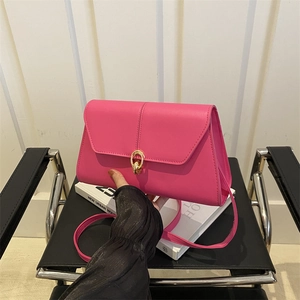 Chic rose red leather crossbody square bag with gold ring clasp and accordion side detail