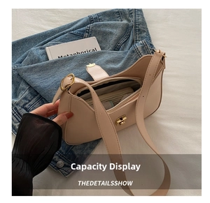 Detailed interior view of beige leather shoulder bag showing large storage and gold clasp