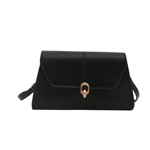 Minimalist black leather crossbody bag with a chic golden double ring metal buckle closure