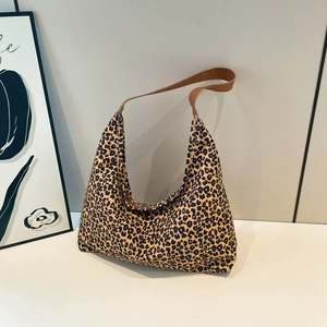 Fashionable large canvas hobo bag with leopard print and brown leather shoulder straps