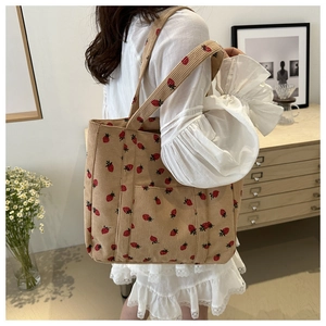 Close-up of strawberry embroidered corduroy tote bag showing large capacity and soft texture