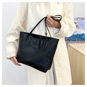 Large capacity black embossed tote bag with elegant geometric patterns for daily commuting