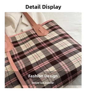 Close-up of pink plaid tote bag with leather handles showing woven fabric texture