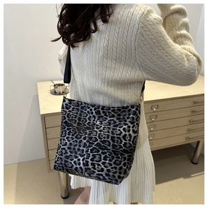 Detailed back view of a leopard print canvas tote bag with adjustable black wide strap