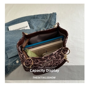 Macro view showing spacious leopard print tote interior with golden ring handles