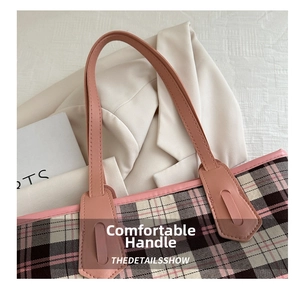 Close-up of pink leather handle with stitching on vintage plaid tote bag detail