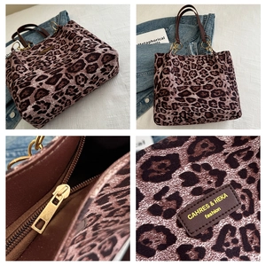 Detail of leopard print tote bag with gold chain and leather brand patch logo