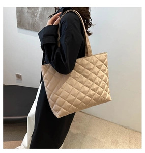Detail view of quilted beige tote bag showing large capacity and lightweight texture