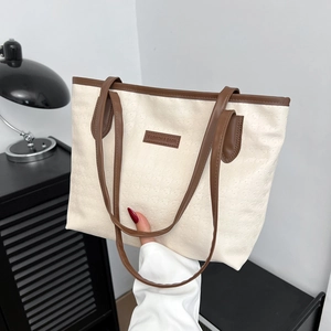 Cream tote bag with houndstooth texture and brown leather straps for modern daily use
