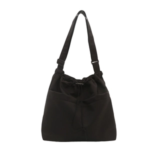 Minimalist black large-capacity shoulder bag with drawstring closure and front pockets
