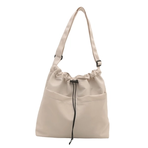 Minimalist beige slouchy bucket bag with drawstring closure and adjustable strap