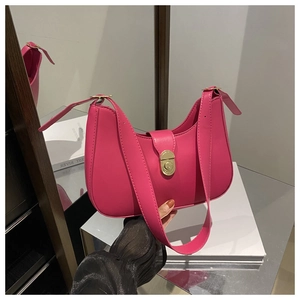 Detail of rose pink crescent bag with golden clasp on high-quality matte faux leather
