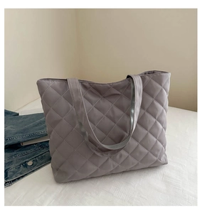 Detail of quilted mauve tote bag showing the soft texture and large rhombus stitching