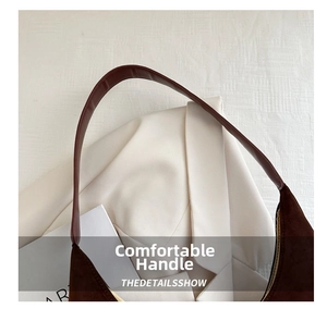 Close-up of comfortable leather handle and dark brown suede texture of the tote bag