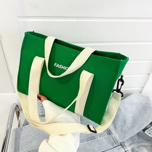 Green canvas tote bag with white FASHION print and adjustable shoulder straps