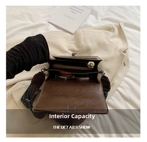 Interior view showing compartments of brown pebbled leather bag with ethnic woven strap