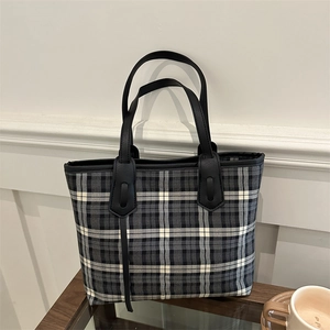 Classic black and white checkered tote bag with leather handles in a retro style