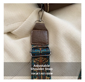 Detail of adjustable brown lychee leather shoulder strap with ethnic geometric pattern